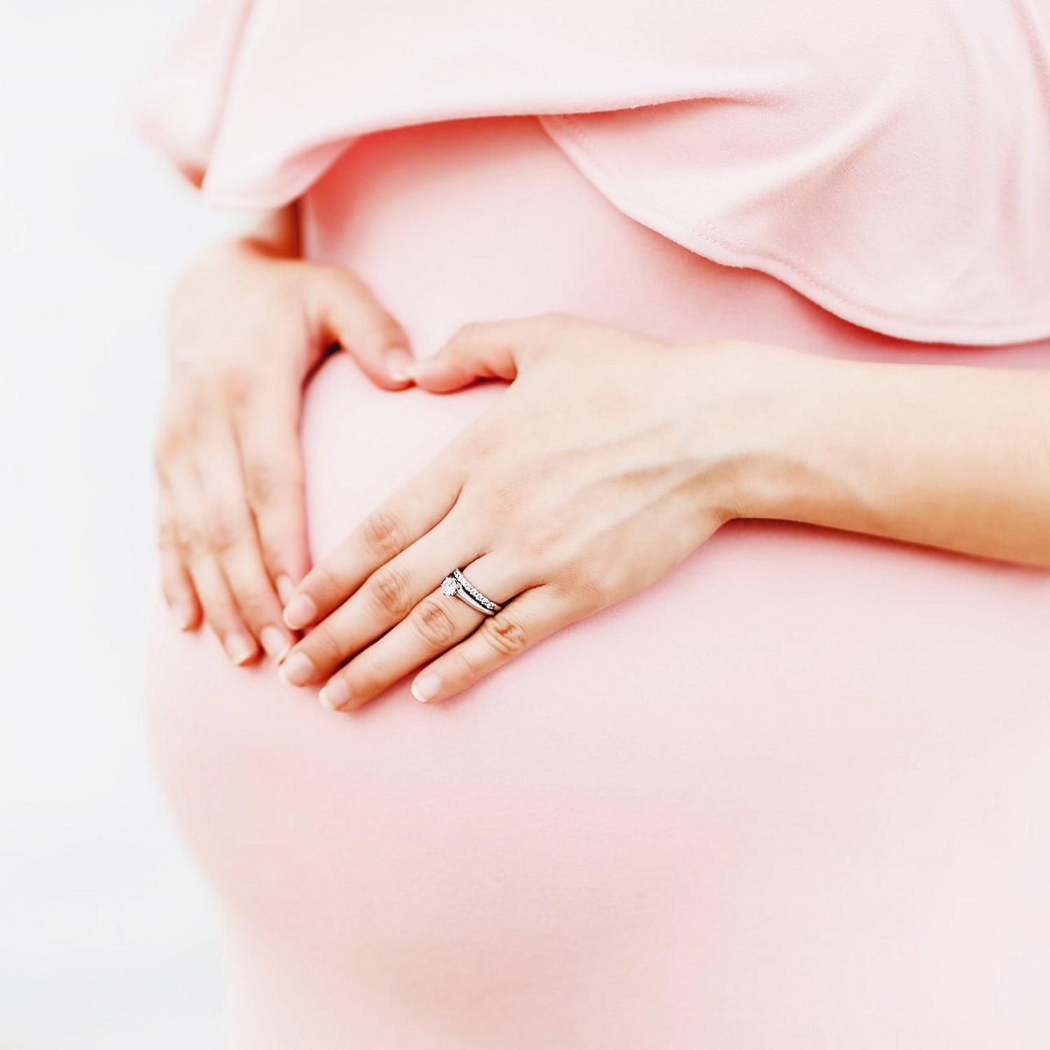 Pregnant Woman In Pink Holding Belly__BoyGirlFeet-Transparent.png